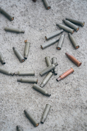 Machine gun empty bullet cartridges lay on the ground after being fired.の写真素材
