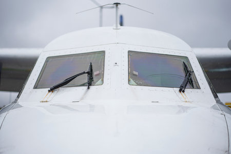 Close front outside view of a white jet plane cockpit.の写真素材