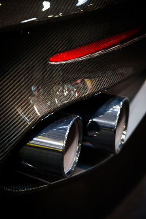 Close up shot of the rear exhaust pipe of a sports car.