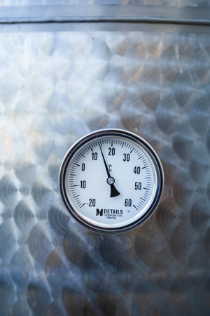 Thermometer gauge detail on an inox background.