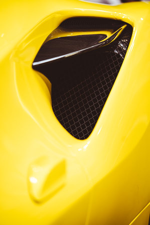 Aerodynamic yellow exotic supercar detail of gloss carbon part with beautiful shapes.の写真素材