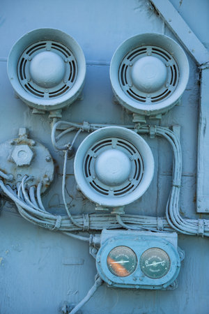 Vintage loudspeakers on a wall of a military ship.