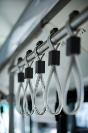 Close up shot of hand handles on public transport.
