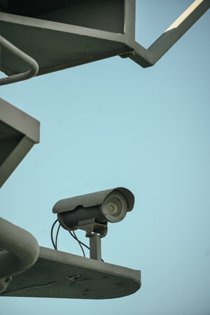 Color image of a surveillance camera on a pole.の写真素材