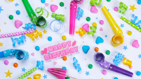 white background with candies, balloons and tubes for birthday or party celebration,concept for birthday,anniversary,congratulationsの写真素材
