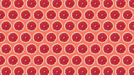 trendy colorful repeating pattern from a photo of half a grapefruit on a orange background.