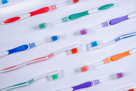 background dental toothbrushes of different colors on a white background top view