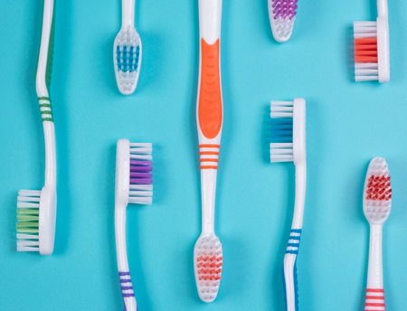 background dental toothbrushes of different colors on a blue background top viewの写真素材