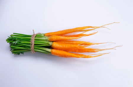 bunch of young carrots on a white backgroundの写真素材