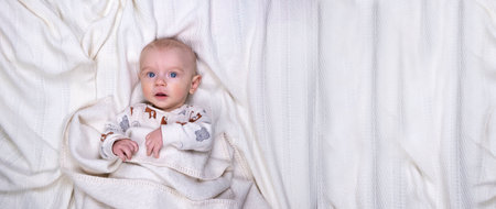 Cute baby boy 5 months old on a light background with place for text