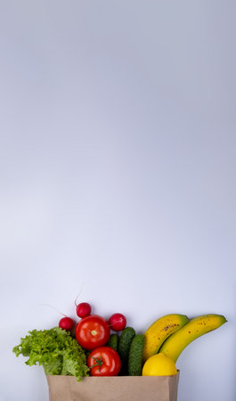 white background with space to insert text with a paper bag for products with vegetablesの写真素材