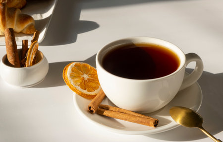 tea in a white mug or cup on a white, light background with fresh pastries and croissants, breakfast or morning conceptの写真素材