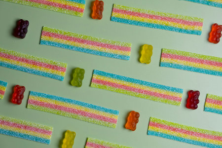 background of various jelly sweets, bears, on green background close-up top view concept birthday party or celebrationの写真素材