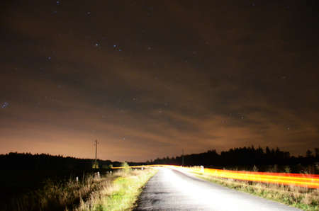 Rural road in the middle of the nightの写真素材