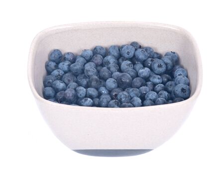 Organic blueberry in ceramic bowl separated on white backgroundの写真素材