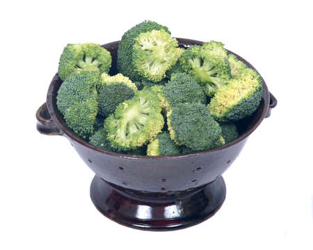 Organic broccoli in berry bowl on white background