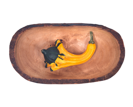 Amish farm colorful pumpkin in olive wood bowl isolated on white backgroundの写真素材