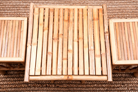 Natural bamboo folding table with chair on jute pile hand woven area rugの写真素材