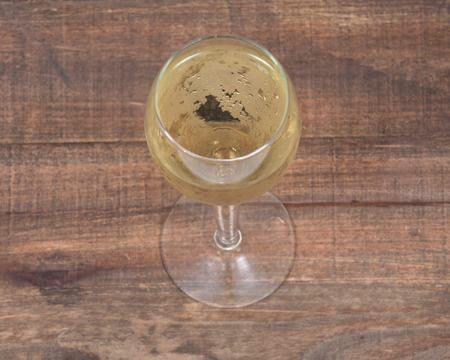 Glass of white wine on vintage wooden backgroundの写真素材