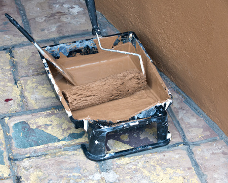 Painted wall and painting supplies: roller, brush, tray liner and paint