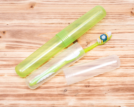 Colorful plastic toothbrush on wooden vintage backgroundの写真素材