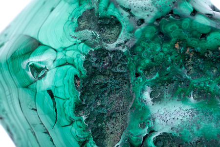 Partially polished green free form bullseye malachite specimen isolated on white backgroundの写真素材
