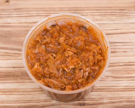 Home made cabbage stew in bpa free plastic container on vintage wooden background