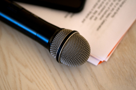 Close up microphone with paper notecards. Concept of speaker preparation to speak. Wedding speech.の写真素材