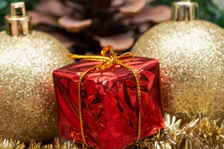 Winter holiday decoration: tinsel garland Christmas gift decor, balls and pine conesの写真素材