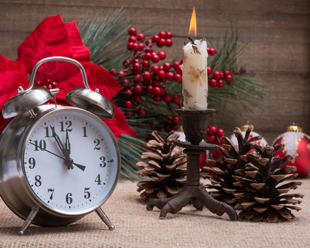 Winter holiday decoration, Christmas and New Year concept with alarm clock: Blooming Red Poinsettia,...