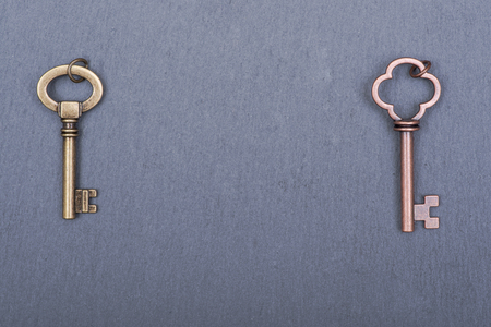 Old vintage metallic keys an natural stone backgroundの写真素材
