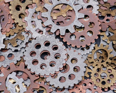 Old vintage antique hour metal gears on natural stone background