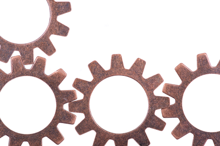 Old vintage antique hour metal gears, cogwheels isolated on white backgroundの写真素材