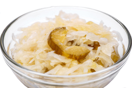 Traditional organic raw and fermented sauerkraut with pickled Persian cucumbers in clear glass bowlの写真素材