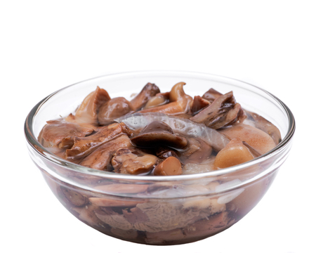 Organic boletus luteus marinated mushrooms in clear glass bowlの写真素材