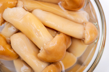 Marinated wine cap mushrooms. Stropharia rugoso annulata mushrooms in clear glass bowlの写真素材