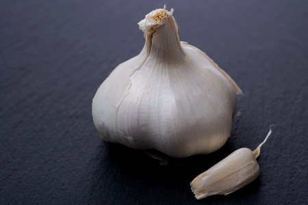 Fresh ripe organic garlic on natural stone background.の写真素材