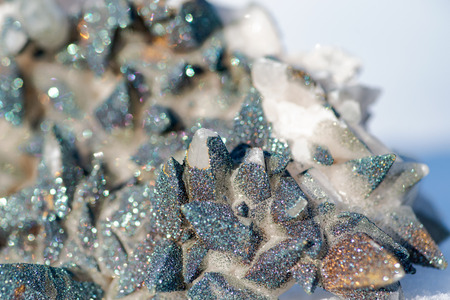 Calcite Cluster Points covered with Pyrite on white snow at a sunny winter day.