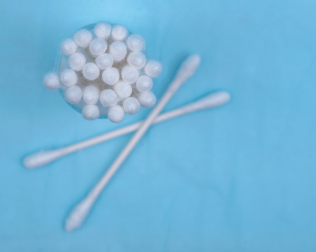 Organic double end white cotton-tipped  ear and make up swabs, buds isolated on blue under pad.の写真素材