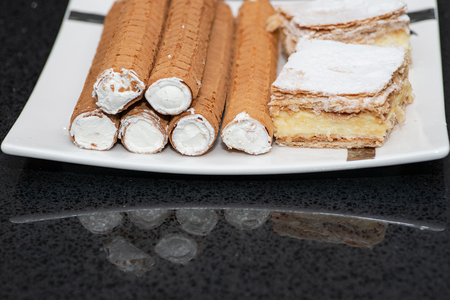 Party platter with arranged sweet desserts from a bakery on banquet table at business or wedding...
