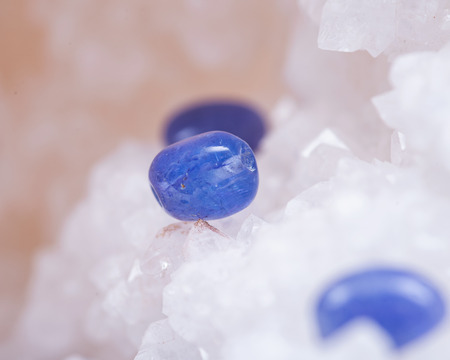 Soft blue violet TANZANITE extra quality beads from Tanzania on crystalline druzy center of clear quartz geode.の写真素材