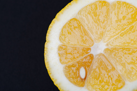Fresh Ripe Organic Lemon cut in half isolated on black background. Citrus Limon. Rutaceae family.の写真素材