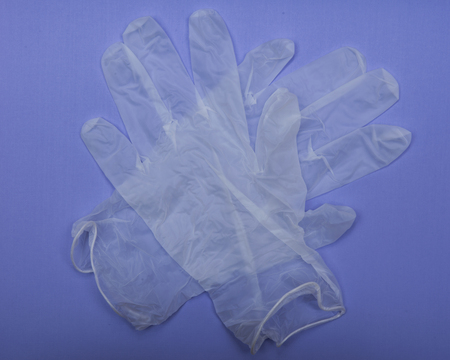 Medical Exam Quality Vinyl Gloves on colorful background.