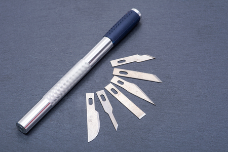 Hobby Knife Set for cutting wood, paper, plastic and cloth on gray stone background.の写真素材