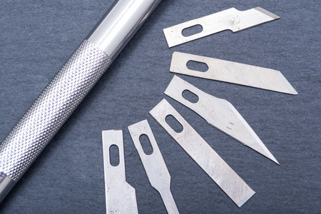 Hobby Knife Set for cutting wood, paper, plastic and cloth on gray stone background.の写真素材