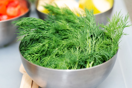Fresh Organic Dill in a stainless steel bowl.の写真素材