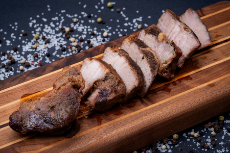 Oven Roasted Pork with spices on wooden cutting board.の写真素材