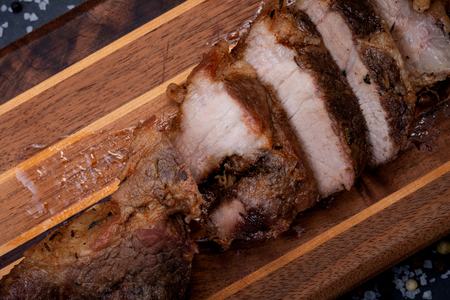 Oven Roasted Pork with spices on wooden cutting board.の写真素材