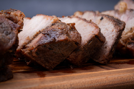 Oven Roasted Pork with spices on wooden cutting board.の写真素材