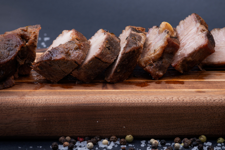 Oven Roasted Pork with spices on wooden cutting board.の写真素材